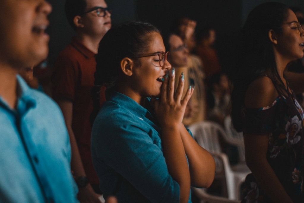 A Woman Praying With Hands Folded Representing A Religious Cult