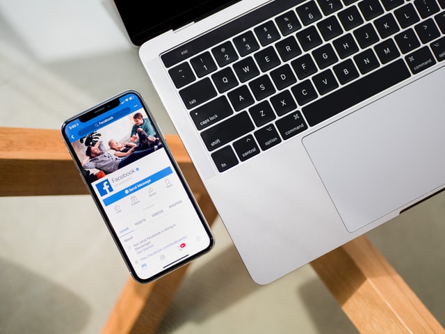 A Phone And A Laptop Sitting On A Table